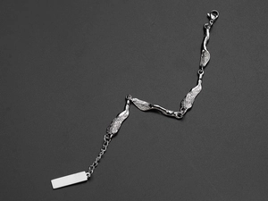 Macro shot of silver irregular metal plate bracelet with lobster clasp on grey background
