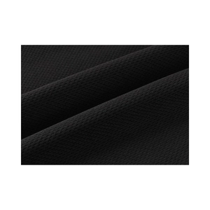 Close-up of black breathable mesh fabric showing detailed texture for sports shorts