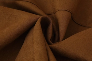 Macro view of dark brown jacket fabric showing fine brushed texture and neat stitching