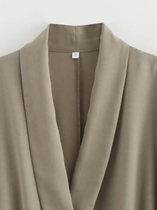 Detailed view of the neckline and fabric texture on a taupe two-piece set with size S tag