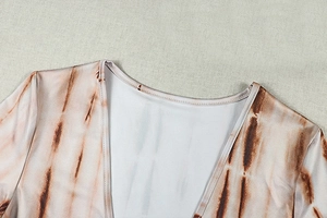 Detail of V-neck collar showing brown and beige tie-dye pattern on soft knitted fabric