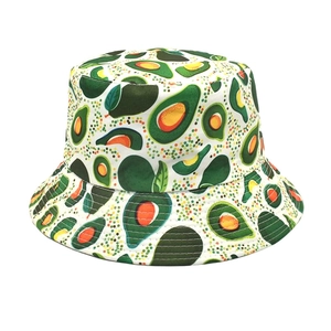 Close-up of bucket hat showing detailed green avocado pattern on breathable cotton fabric