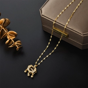 Elegant gold titanium necklace with a sparkling diamond-set Ruyi lock pendant on black stone