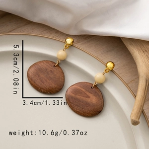 Detailed view of geometric wooden earrings with measurements 5.3cm height and 3.4cm width