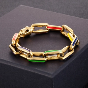 Detail of gold Cuban chain bracelet featuring vibrant multi-color enamel link accents