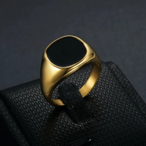 Minimalist gold-plated stainless steel signet ring featuring a polished black enamel inlay