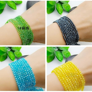 Detail of multi-colored faceted crystal beads in green, blue, yellow, and grey tones