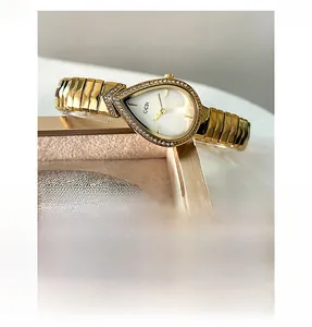 Macro detail of GEDI gold luxury watch with teardrop dial and crystal bezel