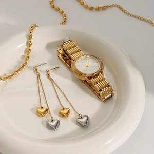 Elegant stainless steel watch with tassel heart earrings and gold chain set in a tray