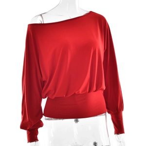 Detail of red off-shoulder long sleeve top with cinched waist and lantern cuffs