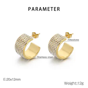 Detailed view of gold C-shaped earrings with multiple rows of white rhinestones