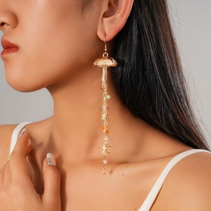 Detailed close-up of gold jellyfish tassel earrings with colorful beads and starfish charms