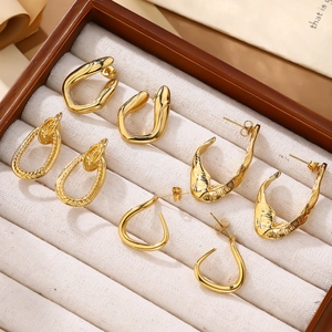 Detail of four pairs of 18k gold plated geometric earrings in a jewelry box display