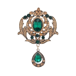 Vintage palace style hollow brooch with large green gems and antique gold finish