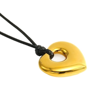 Polished gold heart pendant necklace with black cord on a minimalist white background