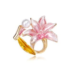 Detailed view of flower brooch with pink lily petals, golden leaves and a white pearl