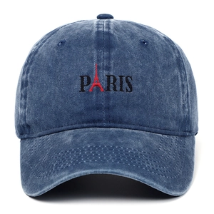 Close-up of Paris embroidery and Eiffel Tower silhouette on washed denim baseball cap