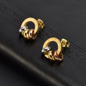 Roman numeral engraved gold earrings with three-tone metallic interlocking rings on leather