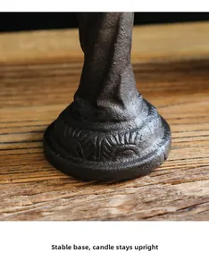 Detail of stable cast iron candle holder base with vintage embossed textures and patterns