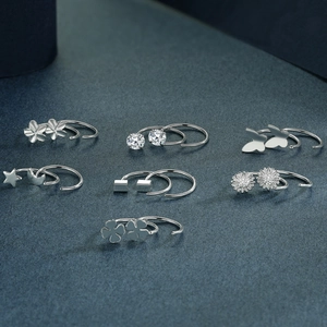 Set of minimalist 999 sterling silver stud earrings with clover, butterfly and heart designs