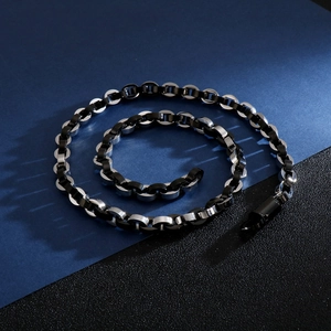 Detail of hiphop cuban link chain featuring black and silver interlocking metal rings