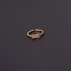 Detail of adjustable gold ring with champagne square zircon and beaded metal texture