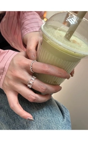 Close-up of minimalist S925 sterling silver beaded and geometric rings on female model