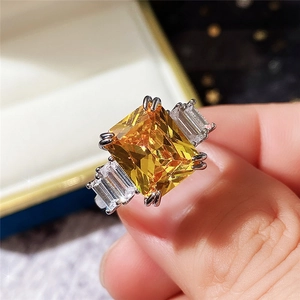 Three-stone emerald cut yellow zircon ring with baguette side stones on silver band