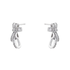 Macro shot of silver bow ribbon stud earrings with shimmering cubic zirconia stones