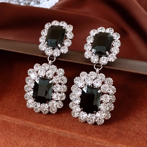 Detail of vintage silver earrings with black rectangular stones and sparkly rhinestones