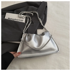 Detail shot of a silver pleated cloud bag with metallic finish and chain strap