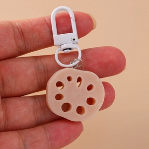 Detailed view of creative lotus root keychain pendant with white metallic ring accessory
