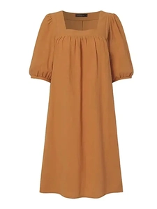 Detail view of the square neckline and bubble sleeves on a caramel linen dress