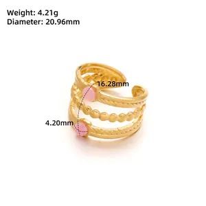 Detailed view of triple-layered wavy gold ring with size measurements and pink gemstones