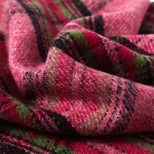 Macro view of red, green, and black plaid cashmere-like fabric showing soft texture
