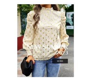 Detail of smocking elastic cuffs and gold foil leaf pattern on a white chiffon blouse