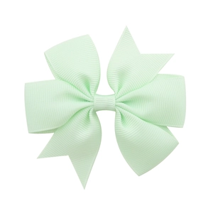Detail shot of light green grosgrain ribbon fishtail bow hair clip for young girls