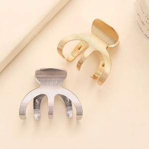 Textured metal hair claw clips in gold and silver finish for sleek high ponytail styling