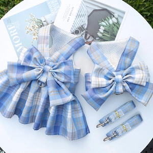 Detail of light blue plaid pet harness dress with bow and matching leash set