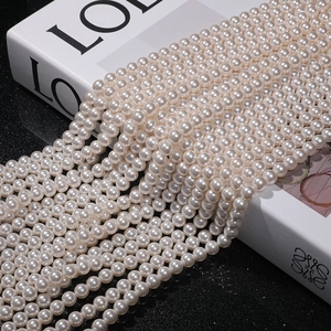 Macro detail of high-luster white round pearls strands with smooth texture and strong shine