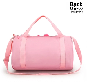 Rear view of pink cylindrical dance bag with adjustable strap and dual top handles