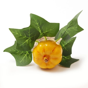 Detailed view of yellow chili napkin ring with green leaves on a rustic burlap band