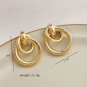 Macro shot of gold layered hoop earrings with 4cm height and 11.4g weight detail