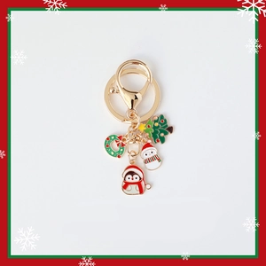 Christmas keychain with gold pendants of Xmas tree, wreath, snowman and penguin