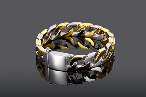 Detail view of two-tone gold and silver Cuban link bracelet with a square clasp