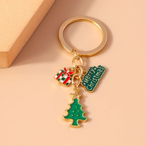 Detailed view of Christmas keychain with gift box, tree, and Merry Christmas charms
