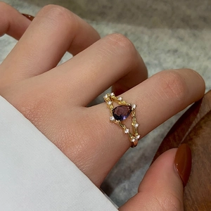Elegant 18K gold ring with a pear-cut purple zircon in a vintage hollowed design