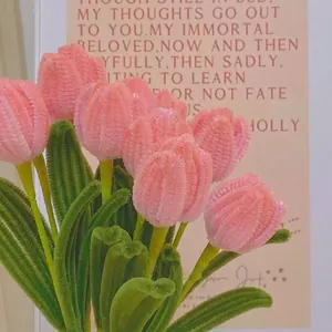 Detailed view of handmade plush tulip bouquet with pink petals and green stems