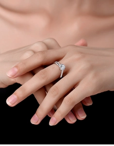 Macro shot of silver sterling ring featuring a round solitaire and micro-pave accents