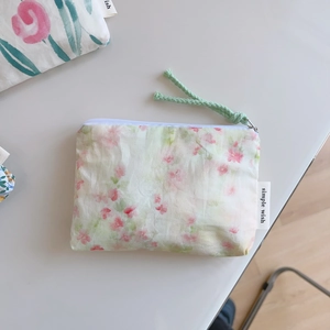 Detailed macro view of cotton floral coin purse with zipper and simple wish label